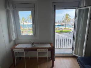 a table and chairs in a room with a balcony at La Sardineta del Serrallo in Tarragona