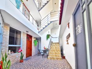 a hallway of a house with stairs and a table at Hospedaje Celerina & Elio in Lima