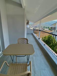 a table and chairs in a room with a balcony at Turgutsluxury 4 in Fethiye