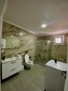 a bathroom with a toilet and a shower and a sink at Turgutsluxury 4 in Fethiye