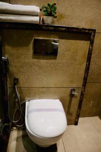 a bathroom with a white toilet in a stall at Hotel Magic Tree Karol Bagh Metro Station New Delhi in New Delhi