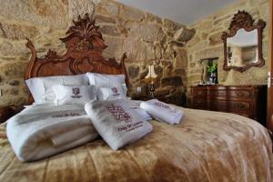 a bedroom with a large bed with pillows on it at Casa de Ladreda in Tangil