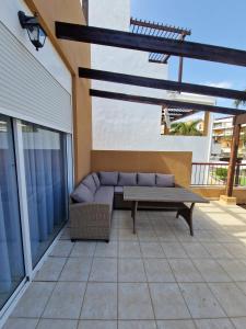 a patio with a couch and a table at Ocean Sunset Villa in San Miguel de Abona