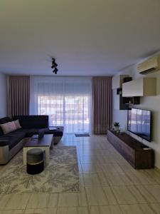 a living room with a couch and a tv at Ocean Sunset Villa in San Miguel de Abona