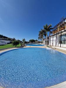 a large swimming pool in front of a building at Ocean Sunset Villa in San Miguel de Abona