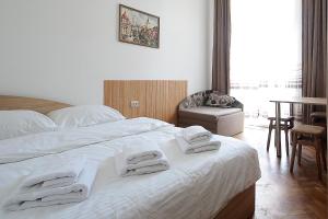 a bedroom with a large bed with towels on it at Deluxe Apartments on Doroshenka 29 in Lviv