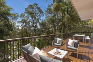 balcón con sofá y sillas en la terraza en Kookaburra House - Terrigal Beach en Terrigal