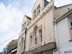 a building on a street with bunting at Bright~ Town Center~ 2 bed~Penzance in Penzance