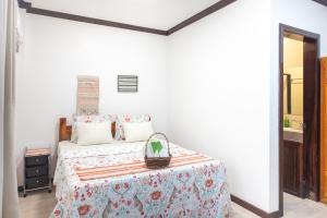 a white bedroom with a bed and a mirror at Siesta Siargao in General Luna