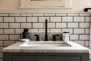 un comptoir de cuisine avec un évier dans une cuisine dans l'établissement Luxe Mid-Century Styled Historic Townhouse #1, à Detroit