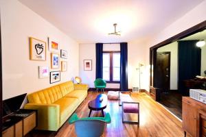 a living room with a couch and a table at Luxe Mid-Century Styled Historic Townhouse #2 in Detroit