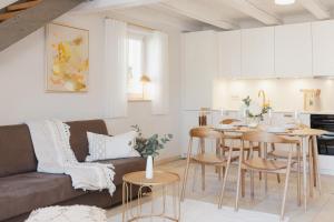 a living room and kitchen with a couch and a table at Ferienwohnung Weidenbach in Weidenbach