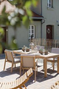 a wooden table and chairs on a patio at Ferienwohnung Weidenbach in Weidenbach +7 photos