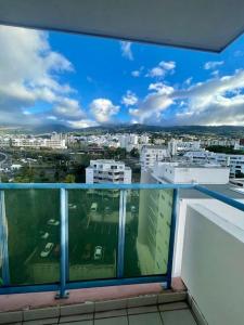 a view of a city from the balcony of a building at L appart dans les Nuages - Climatisé - Piscine - Vues panoramiques - Proche aéroport et Université in Sainte-Clotilde