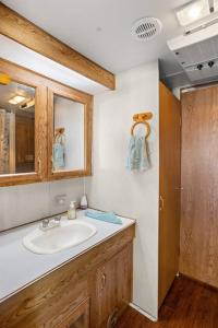 a bathroom with a sink and a mirror at Escape Glamping Tent in Boerne