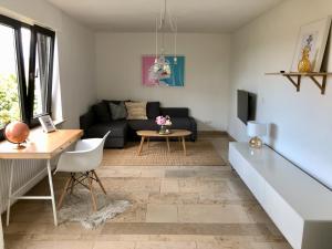 a living room with a couch and a table at ☆ Zentrales Appartement mit traumhaftem Panorama ☆ in Winnenden