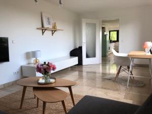 a living room with a vase of flowers on a table at ☆ Zentrales Appartement mit traumhaftem Panorama ☆ in Winnenden +2 photos