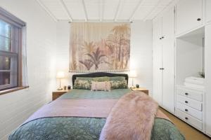 a bedroom with a large bed with a furry blanket at Golden Sands in Henley Beach South