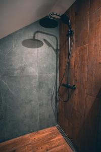 a shower stall with two lights on a wall at Korter vanalinna peatänaval in Viljandi