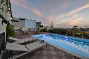 a swimming pool on the roof of a building at Regenta Fairlark Vadodara in Vadodara