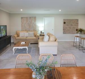 a living room with a couch and a table at Kennedy House Euroa in Euroa