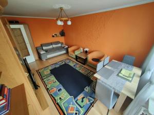 una vista aérea de una sala de estar con paredes de color naranja en Słoneczny Apartament, en Szczecinek