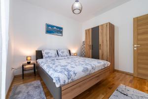 a bedroom with a bed and a wooden cabinet at FOREST GREEN in Kolašin