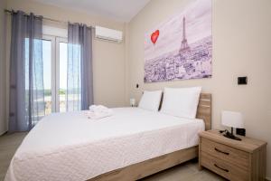 a bedroom with a bed and a large window at Gianni's comfort by homebrain in Alexandroupoli