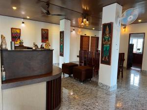 a restaurant with a bar and a dining room at J.J Bed and Breakfast in Port Blair