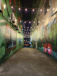 a hallway in a building with paintings on the walls at SaamSaao HomeStay Betong - 4 Bedroom House in Betong