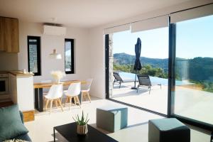 a kitchen and dining room with a view of a house at Heterotopia Villas in Chortáta