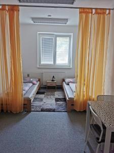 a room with two beds and a window at Living Bratislava & Bus Station & Mlynské Nivy in Bratislava