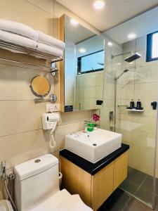 a bathroom with a sink and a toilet and a mirror at Atmosphere De Genting in Genting Highlands