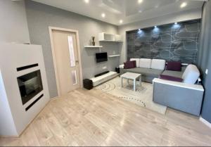 a living room with a couch and a fireplace at Apartament Panoramic ALBA IULIA in Chişinău