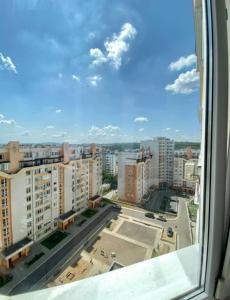 a view of a city from a window at Apartament Panoramic ALBA IULIA in Chişinău