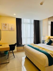 a hotel room with a bed and a desk at Atmosphere De Genting in Genting Highlands