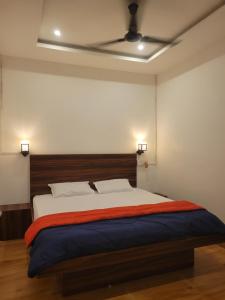 a bedroom with a large bed with a ceiling at Dream Lodging in Silchar