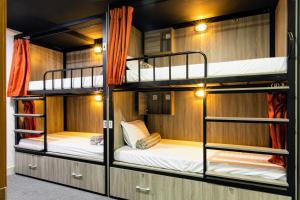 a bunk room with three bunk beds in it at Base Backpackers in Ho Chi Minh City