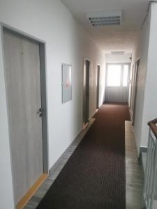 an empty hallway with doors and a carpeted corridor at Living Bratislava & Bus Station & Mlynské Nivy in Bratislava