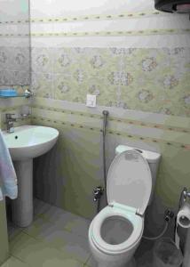 a bathroom with a toilet and a sink at Bhurban Continental Apartment 45-F in Bhurban