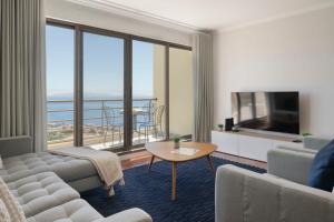 a living room with a couch and a television at Caniço VII by An Island Apart in Santa Cruz