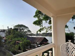 a balcony with a view of the water at Ayutthaya Garden River Home in Ban Bang Krasan