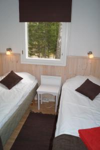 En eller flere senge i et værelse på Hjortö Stugor & Stockhus
