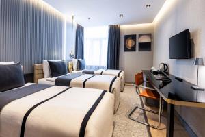 a hotel room with three beds and a television at AHC Taksim Hotel-Special Class in Istanbul +104 photos