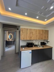 a kitchen with a sink and a counter top at Square Vanilla Boutique Apart-Hotel in Skopje