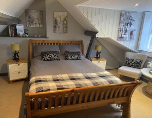 a bedroom with a wooden bed and a staircase at The Foulsyke Licensed Bed and Breakfast Scalby Scarborough in Scarborough
