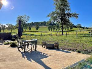 d'une table et de chaises avec vue sur un champ dans l'établissement Dépendance corps de ferme, 