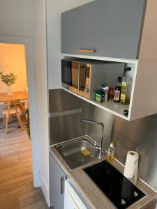a kitchen with a sink and a microwave at Studio moderne au cœur de Paris Batignolles in Paris
