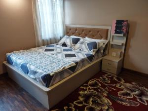 a bedroom with a bed with a blue and white comforter at Nepal christian guest house in Pātan