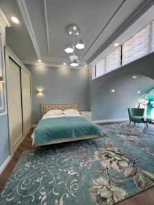a bedroom with a bed and a large rug at RAZAM Hotel Bosteri in Bosteri
